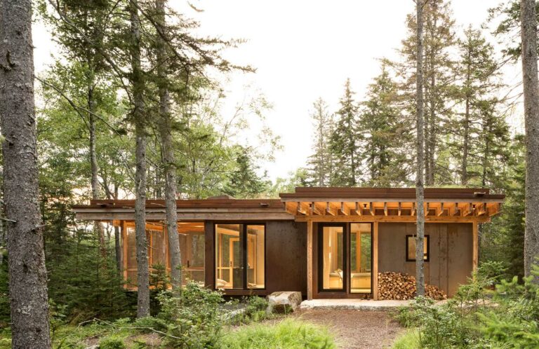 DWELL – A Tiny Cor-Ten Steel Cabin Is in Perfect Sync With the Surrounding Woods